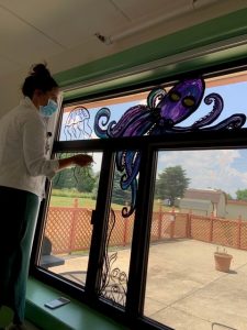 Lauren painting the windows